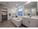 Bright bathroom featuring a large soaking tub, dual vanities, and modern fixtures at 4593 W Bush Bean Way, San Tan Valley, AZ 85144