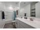 A bright bathroom with a double sink vanity, white cabinets, large mirror, and a tub-shower combo at 4593 W Bush Bean Way, San Tan Valley, AZ 85144