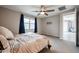 Comfortable bedroom with natural light, ceiling fan, and view to the attached outdoor living area at 4593 W Bush Bean Way, San Tan Valley, AZ 85144