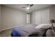 Serene bedroom featuring neutral tones, double closets, and a comfortable bed at 4593 W Bush Bean Way, San Tan Valley, AZ 85144