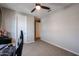 A carpeted bedroom features a ceiling fan and a closet door; neutral gray paint at 4593 W Bush Bean Way, San Tan Valley, AZ 85144