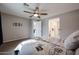 Spacious bedroom with a ceiling fan, neutral walls, and views to the attached bathroom at 4593 W Bush Bean Way, San Tan Valley, AZ 85144