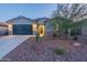 Attractive single-story home features a well-maintained front yard with desert landscaping and stone accents at 4593 W Bush Bean Way, San Tan Valley, AZ 85144