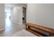 Hallway with wood bench and tile flooring leading into a bright living space at 4593 W Bush Bean Way, San Tan Valley, AZ 85144