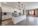 Open-concept kitchen featuring granite counters and stainless appliances seamlessly connects to the dining area at 4593 W Bush Bean Way, San Tan Valley, AZ 85144