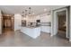 Bright kitchen with white cabinets, granite counters, and a spacious island provides a modern cooking space at 4593 W Bush Bean Way, San Tan Valley, AZ 85144