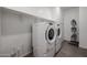 A functional laundry room with a stacked washer and dryer, open shelving, and white walls at 4593 W Bush Bean Way, San Tan Valley, AZ 85144