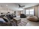 Open living space featuring a sectional sofa, recliner, and views of the kitchen and outdoor area at 4593 W Bush Bean Way, San Tan Valley, AZ 85144