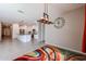 Open-concept living space with a modern kitchen featuring white cabinets and stainless steel appliances at 4593 W Bush Bean Way, San Tan Valley, AZ 85144