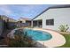 A backyard view featuring a private pool, desert landscaping, and mountain views at 4593 W Bush Bean Way, San Tan Valley, AZ 85144