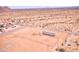 Aerial view of a single-story home on a large fenced lot in a desert landscape with sparse vegetation at 47654 W Venado Rd, Maricopa, AZ 85139