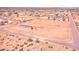 Bird's eye view of a fenced property featuring a single-story home in a sprawling desert community at 47654 W Venado Rd, Maricopa, AZ 85139