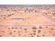 Aerial view of a single-story home on a spacious lot with a chain-link fence in a rural area at 47654 W Venado Rd, Maricopa, AZ 85139