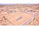 An aerial shot showcasing a compact home surrounded by an expansive fenced yard in a desert landscape at 47654 W Venado Rd, Maricopa, AZ 85139