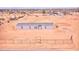 New single-story home with a gray roof and ample land, enclosed by a chain-link fence at 47654 W Venado Rd, Maricopa, AZ 85139