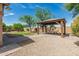Beautifully landscaped backyard with a charming gazebo, perfect for relaxation and outdoor entertaining at 5232 N 186Th Dr, Litchfield Park, AZ 85340