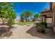 Serene backyard with lush green lawn, desert landscaping, stone accents, and a gazebo providing a relaxing outdoor space at 5232 N 186Th Dr, Litchfield Park, AZ 85340