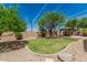 Lush backyard oasis with beautiful desert landscaping, mature trees, a charming gazebo, and a view of the mountains at 5232 N 186Th Dr, Litchfield Park, AZ 85340