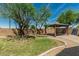 Backyard featuring a gazebo and solar panel with desert landscaping, a green lawn, and mature trees in a private setting at 5232 N 186Th Dr, Litchfield Park, AZ 85340