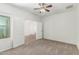 Bedroom featuring neutral carpeting, ceiling fan, and double doors leading to other areas at 5232 N 186Th Dr, Litchfield Park, AZ 85340