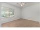 Well-lit bedroom with window, neutral paint, and tile flooring at 5232 N 186Th Dr, Litchfield Park, AZ 85340