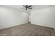 Spacious bedroom features neutral carpet, a ceiling fan, and a door leading to other rooms at 5232 N 186Th Dr, Litchfield Park, AZ 85340