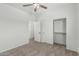 Carpeted bedroom with ceiling fan, closet and adjacent room entries at 5232 N 186Th Dr, Litchfield Park, AZ 85340