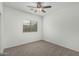 Bedroom features carpeting, neutral decor, a ceiling fan, and a window at 5232 N 186Th Dr, Litchfield Park, AZ 85340