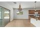 Dining room features an open concept, sliding glass doors, and wood chandelier at 5232 N 186Th Dr, Litchfield Park, AZ 85340