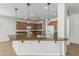 Bright kitchen features wooden cabinets, granite countertops, pendant lights, and stainless steel appliances at 5232 N 186Th Dr, Litchfield Park, AZ 85340