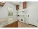 Functional laundry room with granite countertop folding table and built-in shelving for storage, great for organization at 5232 N 186Th Dr, Litchfield Park, AZ 85340
