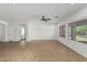 Spacious living room featuring neutral tile flooring, and large windows at 5232 N 186Th Dr, Litchfield Park, AZ 85340