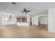 Open-concept living room and kitchen featuring neutral tile flooring, and abundant lighting at 5232 N 186Th Dr, Litchfield Park, AZ 85340