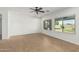Bright living room features tile floors, a ceiling fan, and lots of natural light from the two large windows at 5232 N 186Th Dr, Litchfield Park, AZ 85340