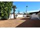 Backyard with privacy wall, gravel, desert plants, and covered patio at 6254 E Winchcomb Dr, Scottsdale, AZ 85254