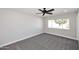 Comfortable bedroom featuring neutral carpeting, a ceiling fan, and a bright window at 6254 E Winchcomb Dr, Scottsdale, AZ 85254