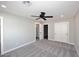 Spacious bedroom featuring neutral carpeting, a ceiling fan, and walk-in closet at 6254 E Winchcomb Dr, Scottsdale, AZ 85254