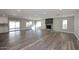 Spacious living room boasting a fireplace, wood-look floors, and ample natural light at 6254 E Winchcomb Dr, Scottsdale, AZ 85254