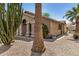 Side view of a home with desert landscaping, palm and cactus trees at 6621 S Coral Gable Dr, Chandler, AZ 85249