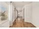 Bright hallway with wood floors, white textured walls, and natural light from a large window at 6621 S Coral Gable Dr, Chandler, AZ 85249