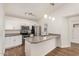 Well-lit kitchen features granite countertops, stainless steel appliances, and white cabinets at 6621 S Coral Gable Dr, Chandler, AZ 85249