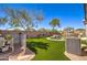 Expansive backyard with artificial turf, private pool, and an air conditioning unit and filter at 709 E Dry Creek Rd, San Tan Valley, AZ 85143