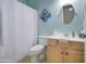 Cozy bathroom featuring light blue walls, a round mirror, and a white shower curtain at 709 E Dry Creek Rd, San Tan Valley, AZ 85143
