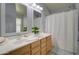 Bright bathroom featuring dual sinks, neutral tiling, and a shower-tub combo at 709 E Dry Creek Rd, San Tan Valley, AZ 85143