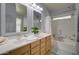 Bright bathroom featuring dual sinks, neutral tiling, and a shower-tub combo at 709 E Dry Creek Rd, San Tan Valley, AZ 85143