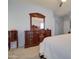 Bedroom boasts neutral walls, soft carpet, and matching dressers and mirror at 709 E Dry Creek Rd, San Tan Valley, AZ 85143