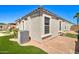 Home exterior showing the landscaped yard, air conditioning unit and gravel for low maintenance at 709 E Dry Creek Rd, San Tan Valley, AZ 85143