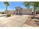 Inviting home with desert landscaping, fountain and palm tree in the front yard at 709 E Dry Creek Rd, San Tan Valley, AZ 85143