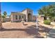 Beautiful single-story home showcasing desert landscaping, decorative fountain, and covered entryway at 709 E Dry Creek Rd, San Tan Valley, AZ 85143
