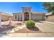 Charming single-story home featuring a well-manicured yard and an inviting arched entryway at 709 E Dry Creek Rd, San Tan Valley, AZ 85143